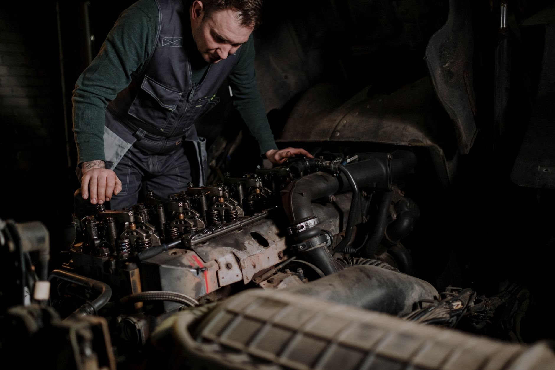 Mechanic focused on vehicle engine repair in an indoor workshop